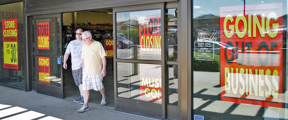 Two men exit Sport Chalet in La Cañada Flintridge on Tuesday, April 19, 2016. Sport Chalet's parent company, Vestis Retail Group, said Monday that it had filed for Chapter 11 bankruptcy protection.