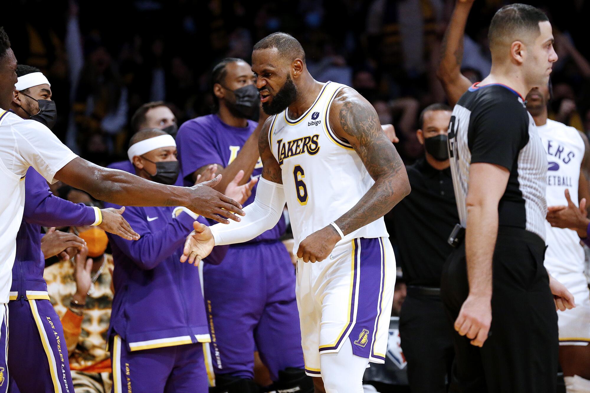 Lakers forward LeBron James celebrates after scoring a basket against the Brooklyn Nets in the first half.