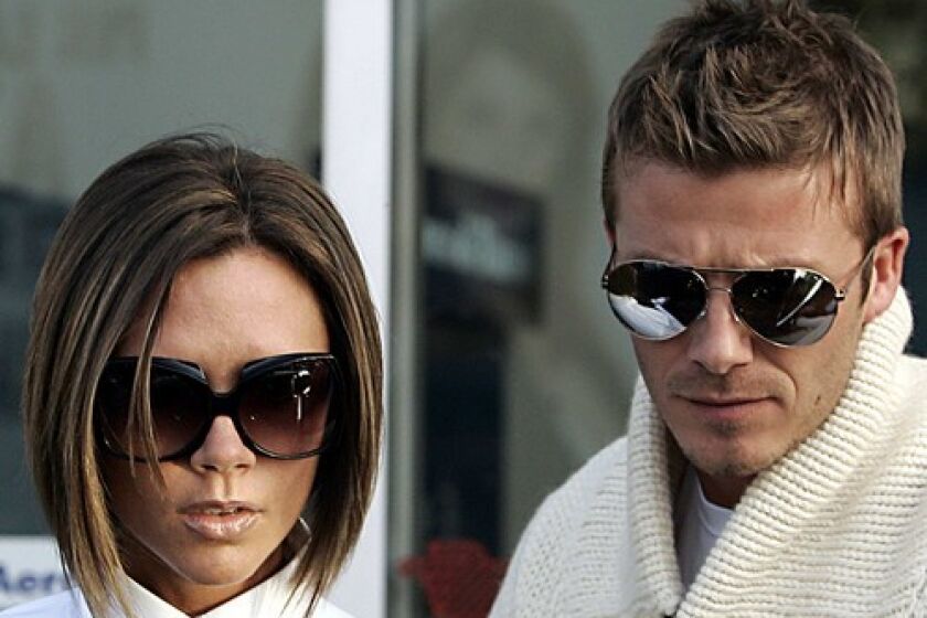 David Beckham and his wife Victoria arrive at Ciampino airport in Rome. Britons have qualms about a knighthood for the L.A.-bound soccer star -- not least of which is the notion of Lady ('Posh Spice') Beckham.