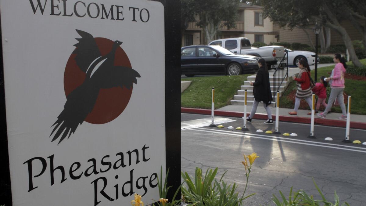 Three pregnant women and a child enter the Pheasant Ridge apartment complex in Rowland Heights. The complex is home to at least one maternity hotel, run by a company called Mother of American.