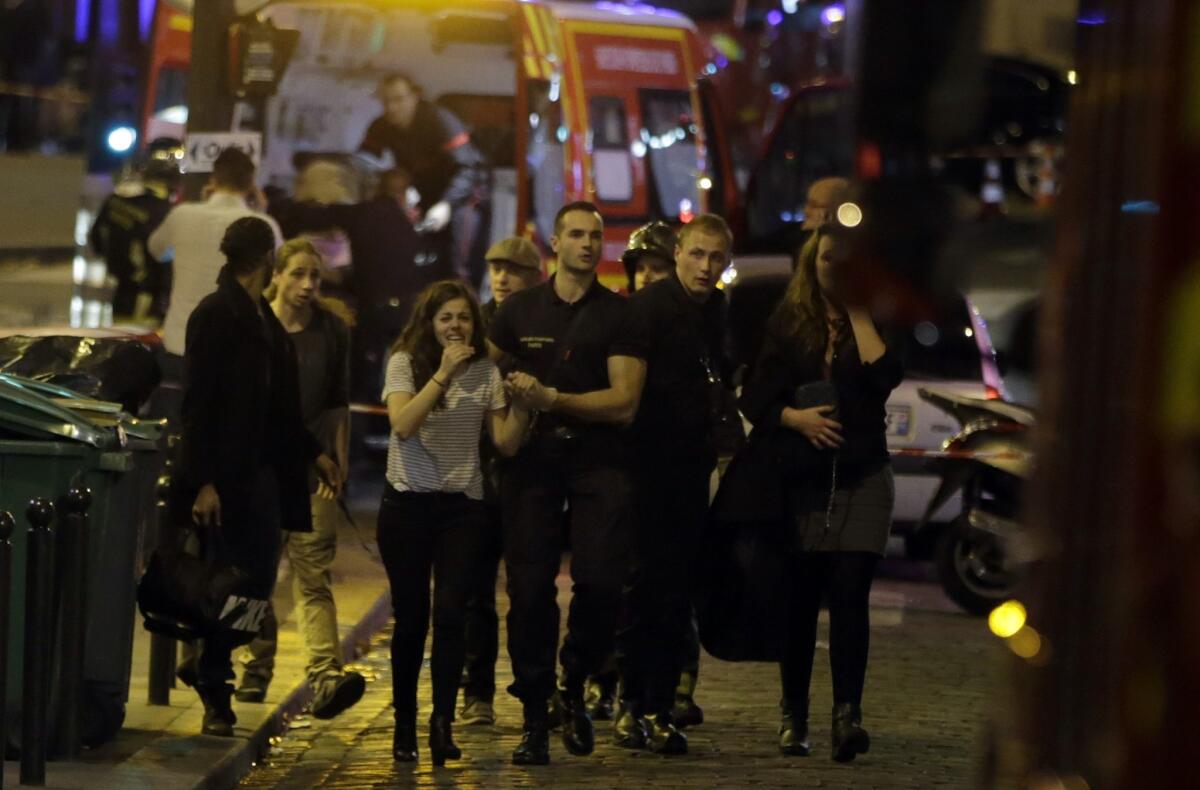 Rescuers evacuate people following an attack in the 10th arrondissement of the French capital Paris on Friday night.