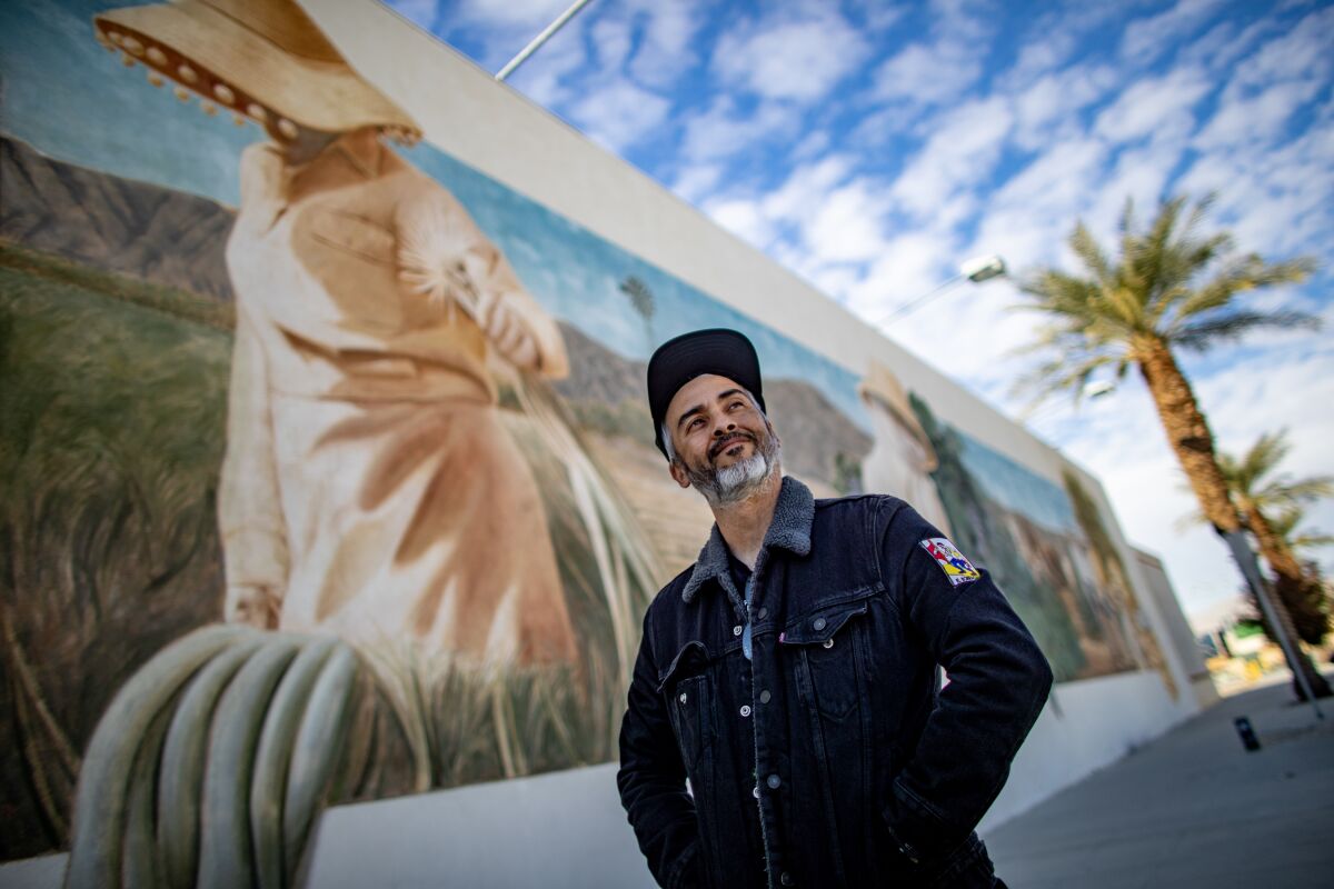 Juan Carlos Barajas, Indio Tamale Festival culinary director, stands in front of an iconic mural in downtown Indio