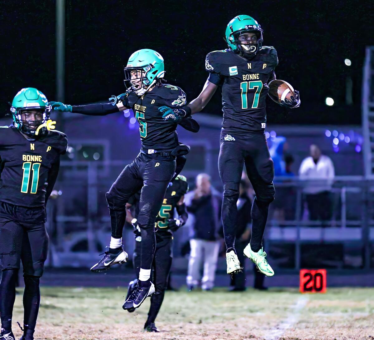 Ernest Nunley (17) leaps for joy with Narbonne teammates after making a key interception against Birmingham on Friday night.