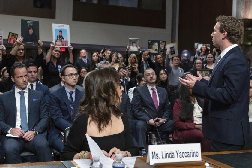 Meta CEO Mark Zuckerberg turns to address the audience during a Senate Judiciary Committee hearing on Capitol Hill in Washington, Wednesday, Jan. 31, 2024, to discuss child safety. X CEO Linda Yaccarino watches at left. (AP Photo/Jose Luis Magana)