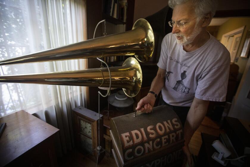 SILVER LAKE, CALIF. - AUGUST 24, 2019: Collector John Levin of Silver Lake, Calif. show the Los Angeles Times some of his renowned wax cylinder at his home on Saturday, Aug. 24, 2019. According to Levin he is standing next to “a 1900 double-horned phonograph used in the traveling media shows that were typical of the era. This machine easily filled a large tent with music.” (Francine Orr / Los Angeles Times)