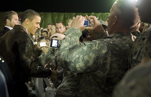 President Obama greets troops at Bagram air base outside Kabul. He thanked the Afghan people and U.S. troops for their sacrifices in the war in Afghanistan, and vowed to reverse the Taliban's momentum. Full report
