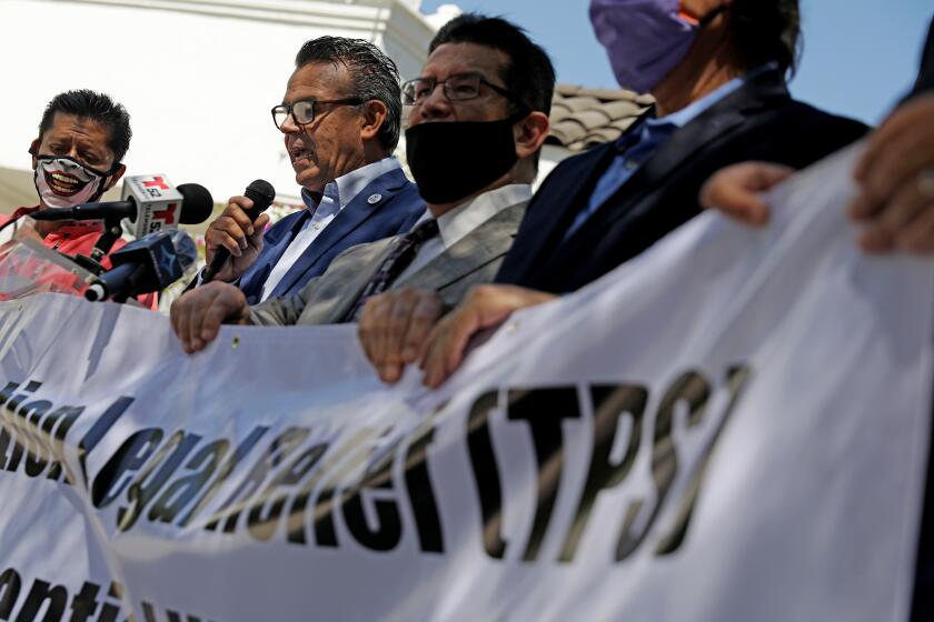 LOS ANGELES-CA-JUNE 11, 2020: Pro immigrant rights leaders including Francisco Moreno, General Coordinator for Mexican Migrants Abroad, second from left, speaks at a news conference to call on President Donald Trump to extend temporary protected status to workers in the country without legal permission who were deemed by him to be essential workers during the coronavirus pandemic, at Placita Olvera in Los Angeles, California on Thursday, June 11, 2020. (Christina House / Los Angeles Times)