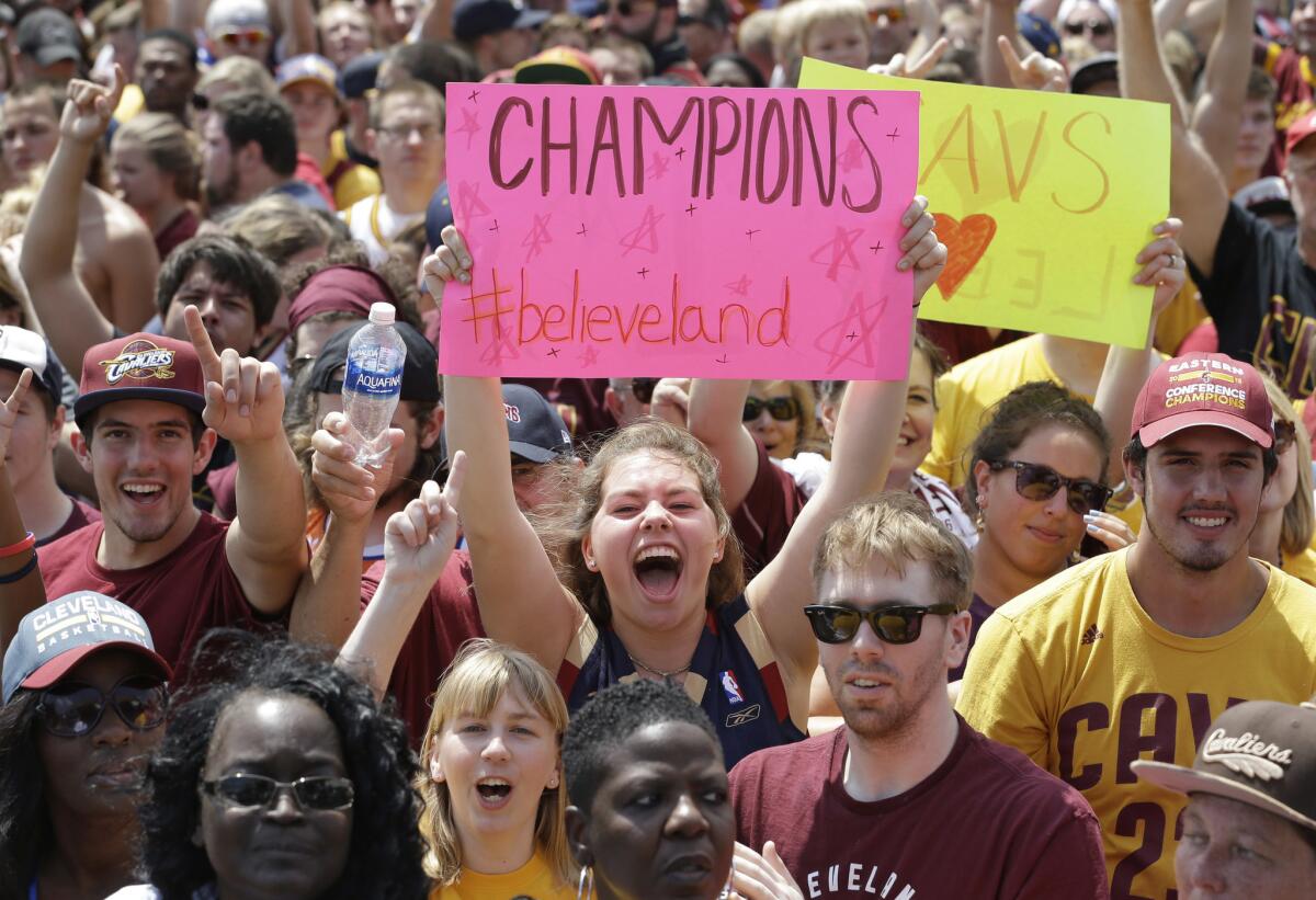 Cleveland Cavaliers fans cheer as they wait for the team's return on Monday. (Tony Dejak / Associated Press)