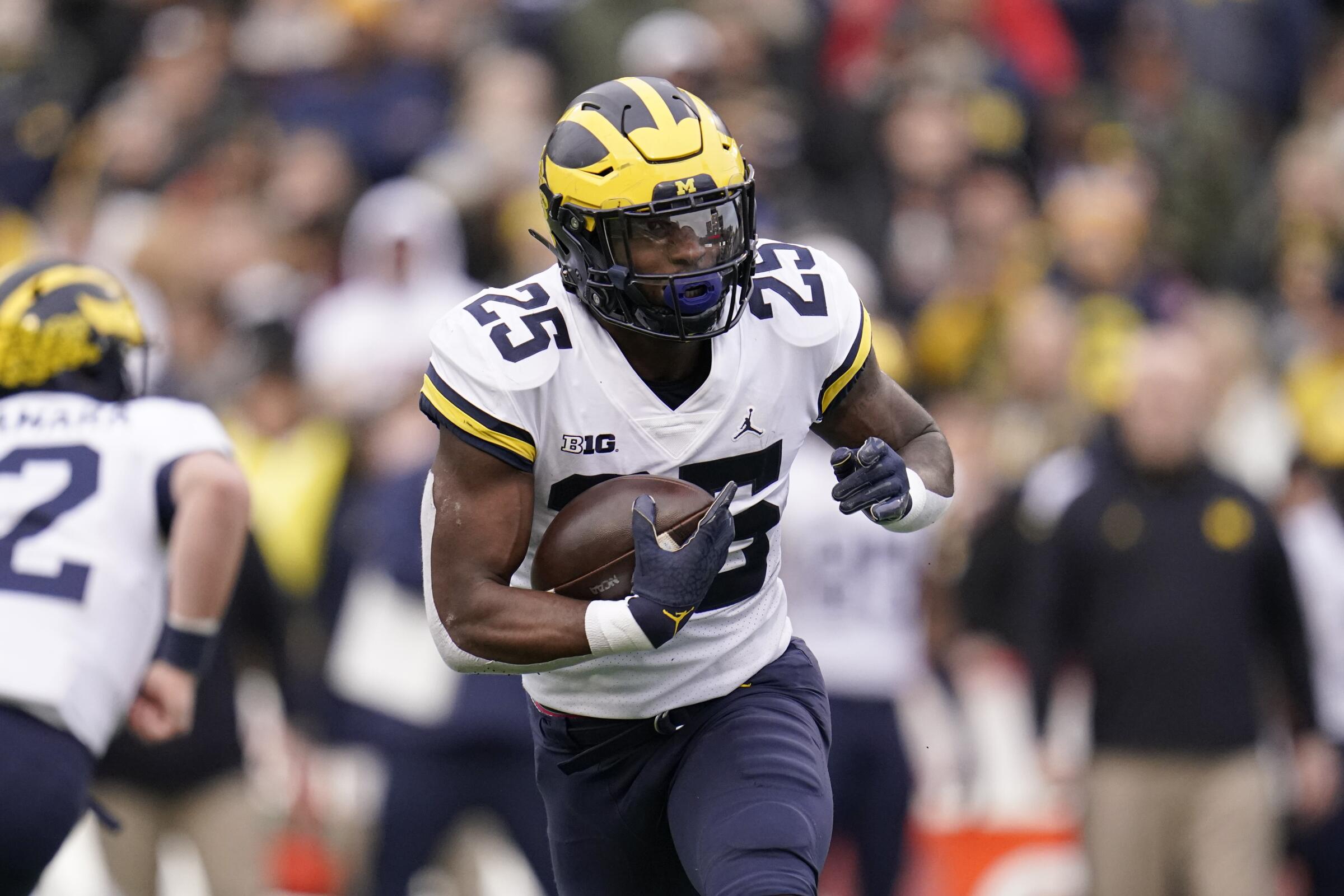 Michigan running back Hassan Haskins runs with the ball against Maryland.