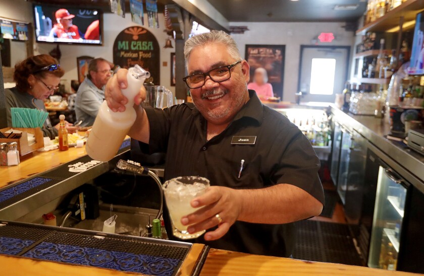 Bartender Juan Alvarez makes a margarita in the bar at Mi Casa on May 5, the restaurant's 50th anniversary.