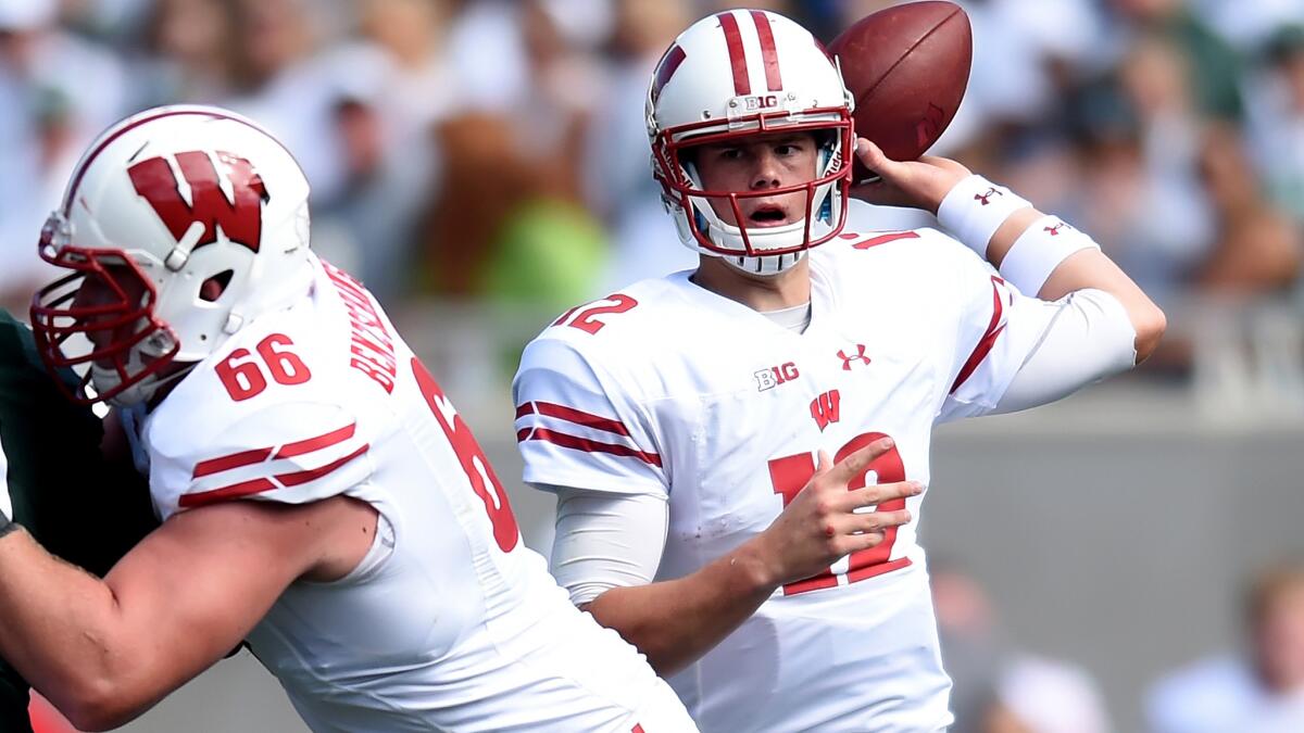 Wisconsin quarterback Alex Hornibrook spots receiver as he passes against Michigan State on Saturday.