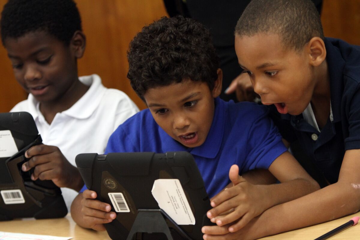 Students at Broadacres Elementary school in Carson explore the possibilities with their new LAUSD provided iPads in August. The district wants to tap about $1 billion in bond money to provide every student, teacher and administrator with a digital tablet.