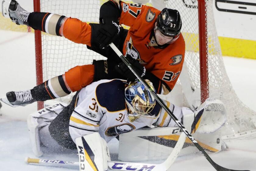 Ducks forard Nick Ritchie tumbles over Sabres goalie Anders Nilsson during the third period Friday night.
