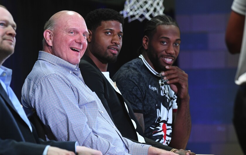 Clippers owner Steve Ballmer is all smiles during the introductory news conference for Paul George, center, and Kawhi Leonard, right.