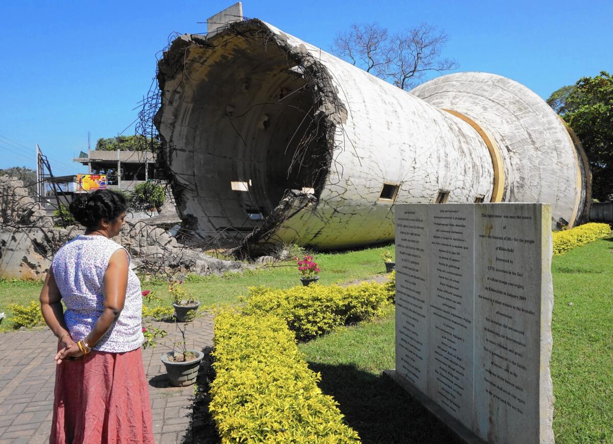 A water tank destroyed in the Sri Lankan civil war now stands as a memorial in Kilinochchi, along the A9 highway that links southern Sri Lanka with the northern areas that were the main battlegrounds of the conflict. (Shashank Bengali/ Los Angeles Times)