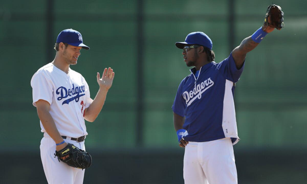 Dodgers pitcher Clayton Kershaw, left, and shortstop Hanley Ramirez talk during a spring-training practice session on Feb. 20. Kershaw will take the mound in the Dodgers' season opener Saturday against the Arizona Diamondbacks in Australia.