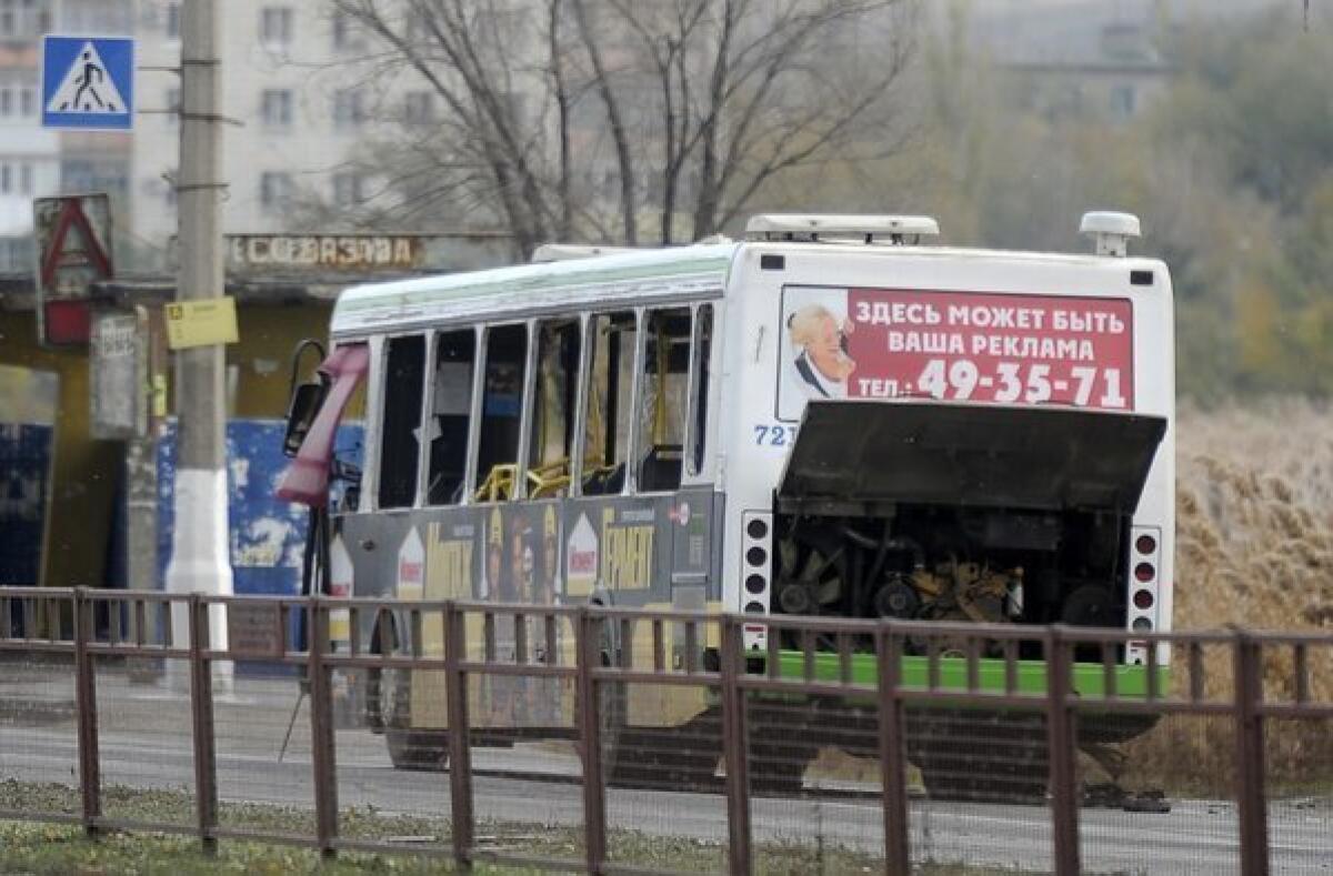 Authorities examine a bus damaged by an explosion in Volgograd, Russia. Officials said the blast was set off by a suicide bomber.