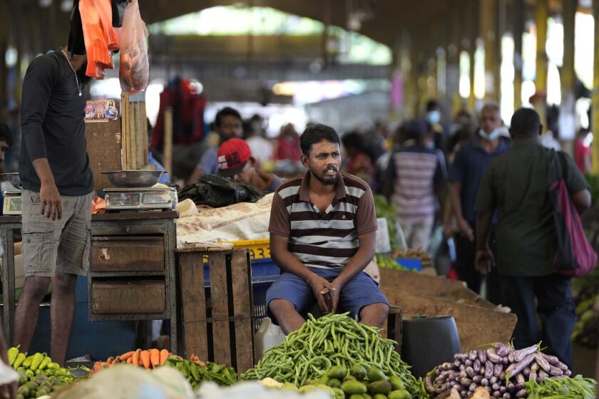 FILE - A vender waits for customers at a vegetable market place in Colombo, Sri Lanka, Friday, June 10, 2022. China’s government on Friday, Feb. 2, 2023, confirmed it is offering Sri Lanka a two-year moratorium on loan repayment as the Indian Ocean island nation struggles to restructure $51 billion in foreign debt that pushed it into a financial crisis. (AP Photo/Eranga Jayawardena)