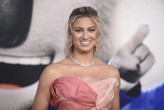 Tori Kelly with her hair pulled back smiling in a multi-shade pink, strapless dress