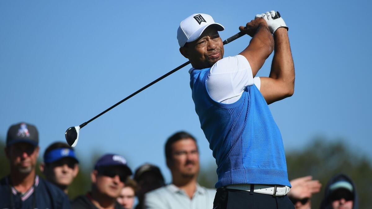Tiger Woods plays his shot from the second tee Thursday during the Farmers Insurance Open at Torrey Pines South.