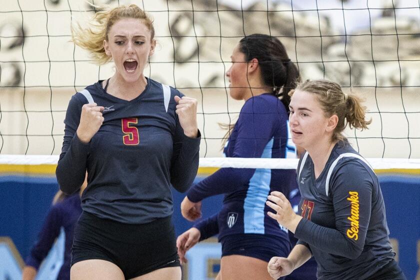 Ocean View's Helen Reynolds, left, celebrates after winning a point during a match against Marina on Wednesday, August 22.
