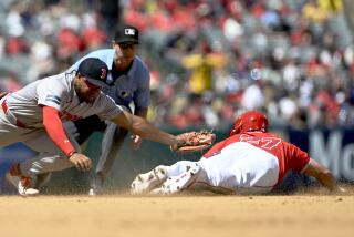 Boston Red Sox second baseman Enmanuel Valdez, left, misses on a tag as Los Angeles Angels' Mike Trout (27) steals second during the third inning of a baseball game in Anaheim, Calif., Sunday, April 7, 2024. (AP Photo/Alex Gallardo)