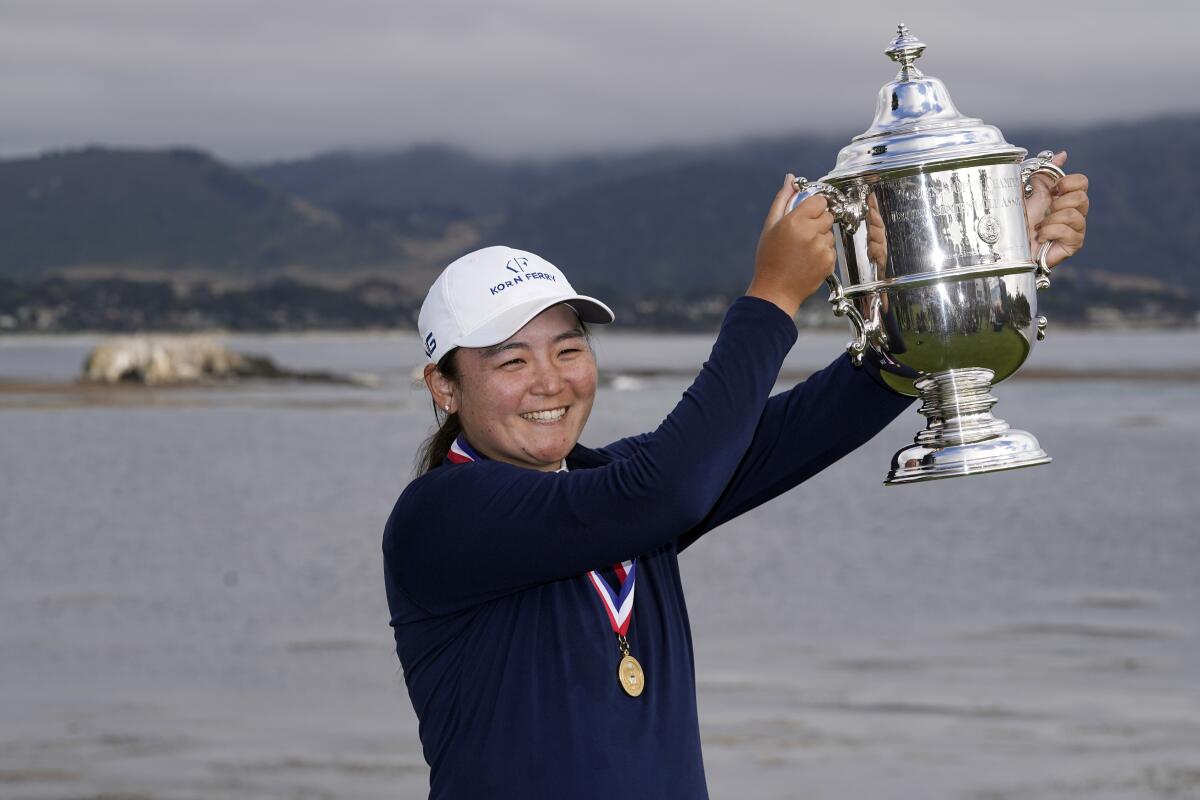 Allisen Corpuz poses with the winner's trophy after the U.S. Women's Open golf tournament at Pebble Beach Golf Links.