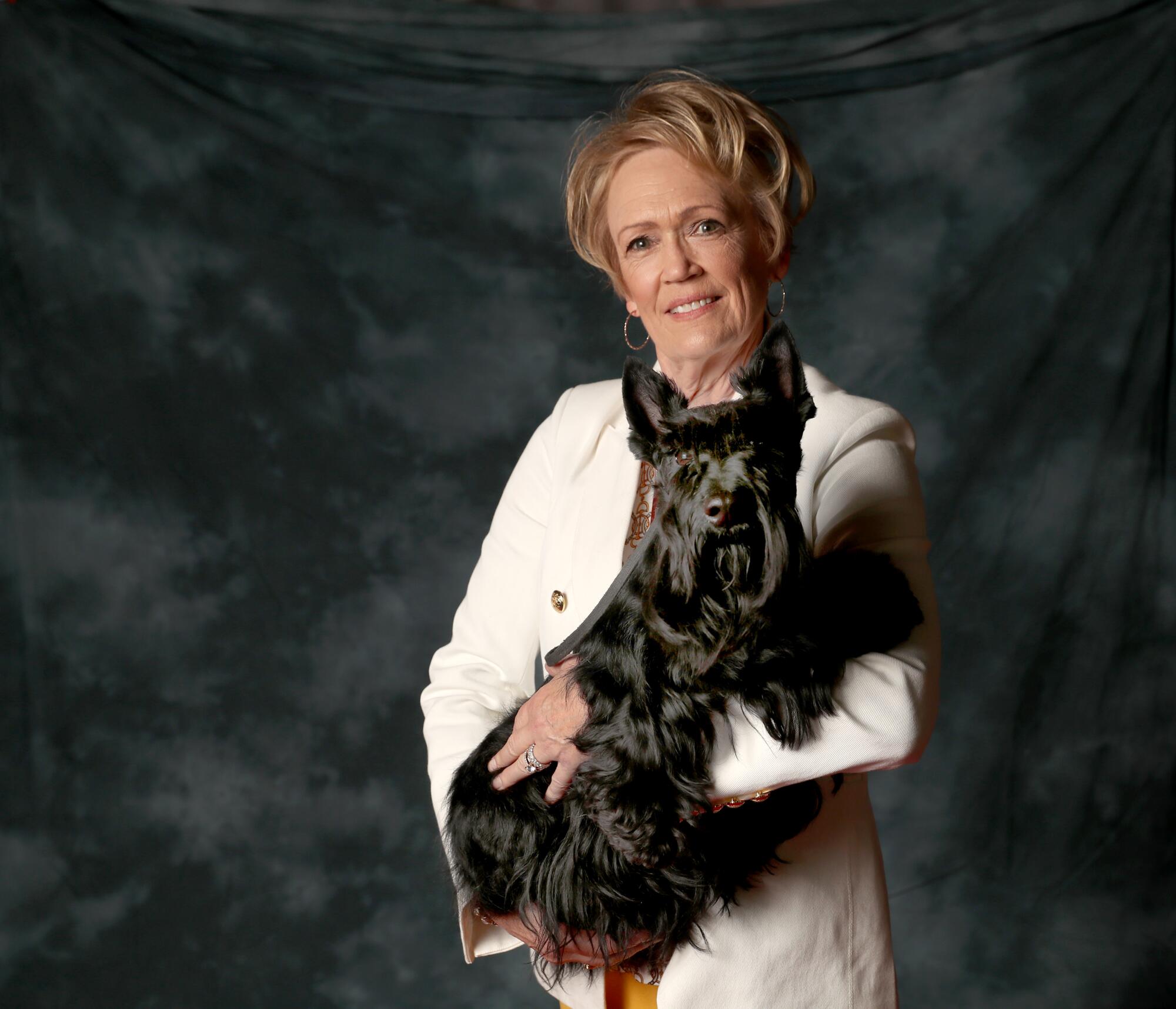 Connie Kling, 65, poses with her 3-year-old grand champion Scottish terrier, Annika. Annika loves freeze-dried liver.