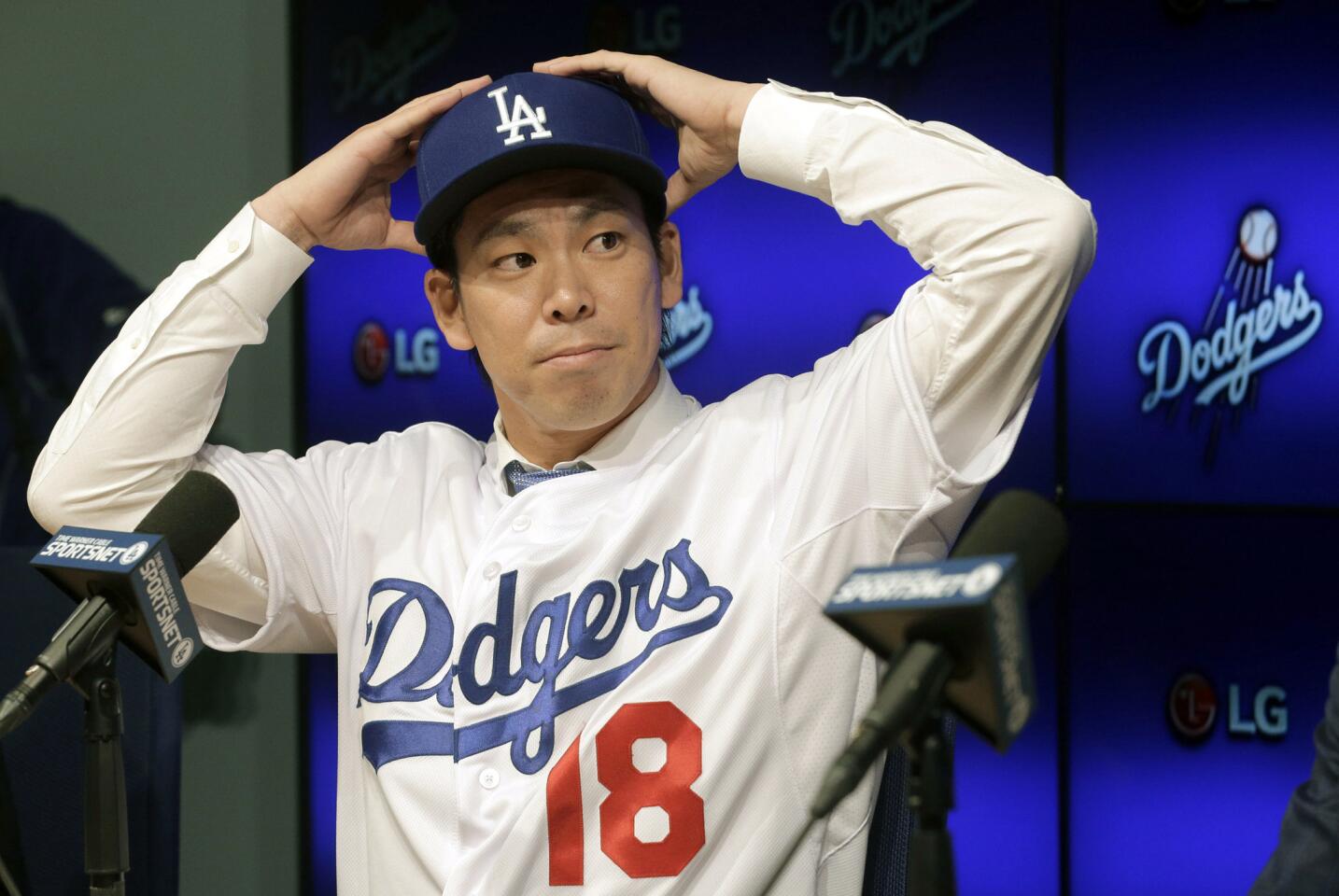 Newly signed Los Angeles Dodgers pitcher Kenta Maeda, from Japan, is introduced at a news conference in Los Angeles Thursday, Jan. 7, 2016. Maeda, 27, signed an eight-year contract with the baseball club that guarantees the right-hander $25 million, but he can earn more than $100 million during the length of the deal if he meets all performance incentives.(AP Photo/Nick Ut)