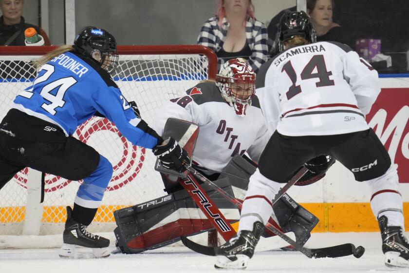 Toronto's Natalie Spooner (24) scores her second goal of the game against Ottawa goalie Emerance Maschmeyer, center, as Ottawa's Hayley Scamurra (14) defends during third-period PWHL hockey action in Toronto, Sunday May 5, 2024. It was Spooner's 20th goal of the season. (Frank Gunn/The Canadian Press via AP)