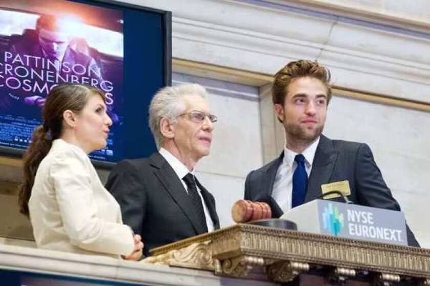 Robert Pattinson and David Cronenberg ring the opening bell at NYSE to promote their upcoming film, "Cosmopolis."