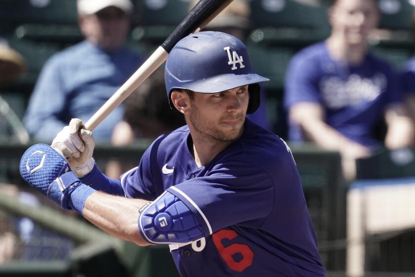 Los Angeles Dodgers' Trea Turner bats during the first inning of a spring training baseball game against the Texas Rangers Thursday, March 31, 2022, in Surprise, Ariz. (AP Photo/Charlie Riedel)