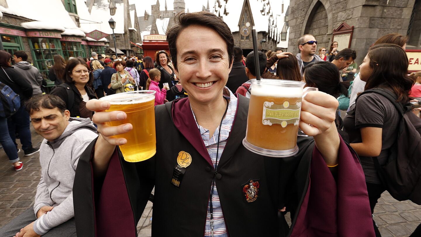 Sereena Worino tries the attraction's butterbeer on opening day.