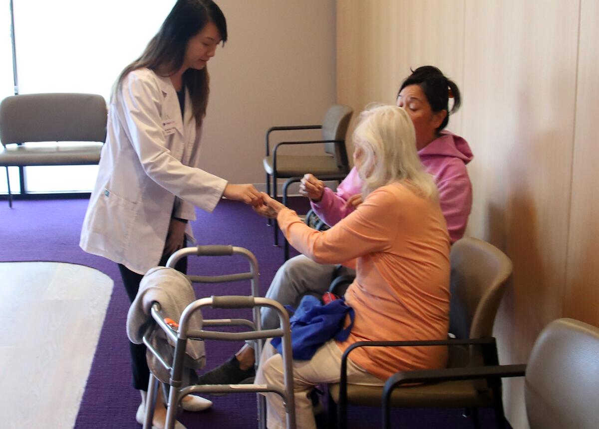 Dr. Katherine Yeh helps a patient at the HearUSA Hearing Center of the Future.