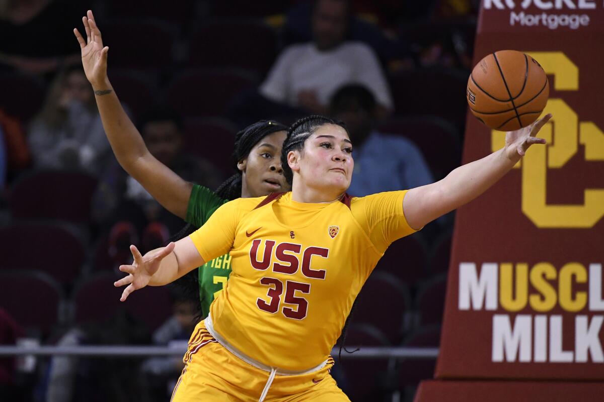 USC forward Alissa Pili, right, grabs a pass in front of Oregon forward Ruthy Hebard defends during the Ducks' 93-67 win Sunday.
