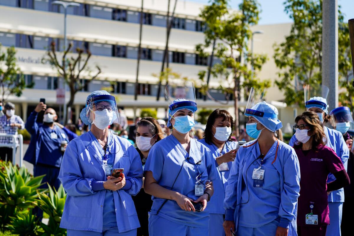 St. Jude Medical Center staffers gather on the sidewalk as firefighters show support for healthcare workers this month in Fullerton.