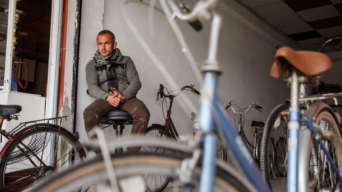 Mohammed Sabah Yehia, 32, sits in his new bicycle store in east Mosul.