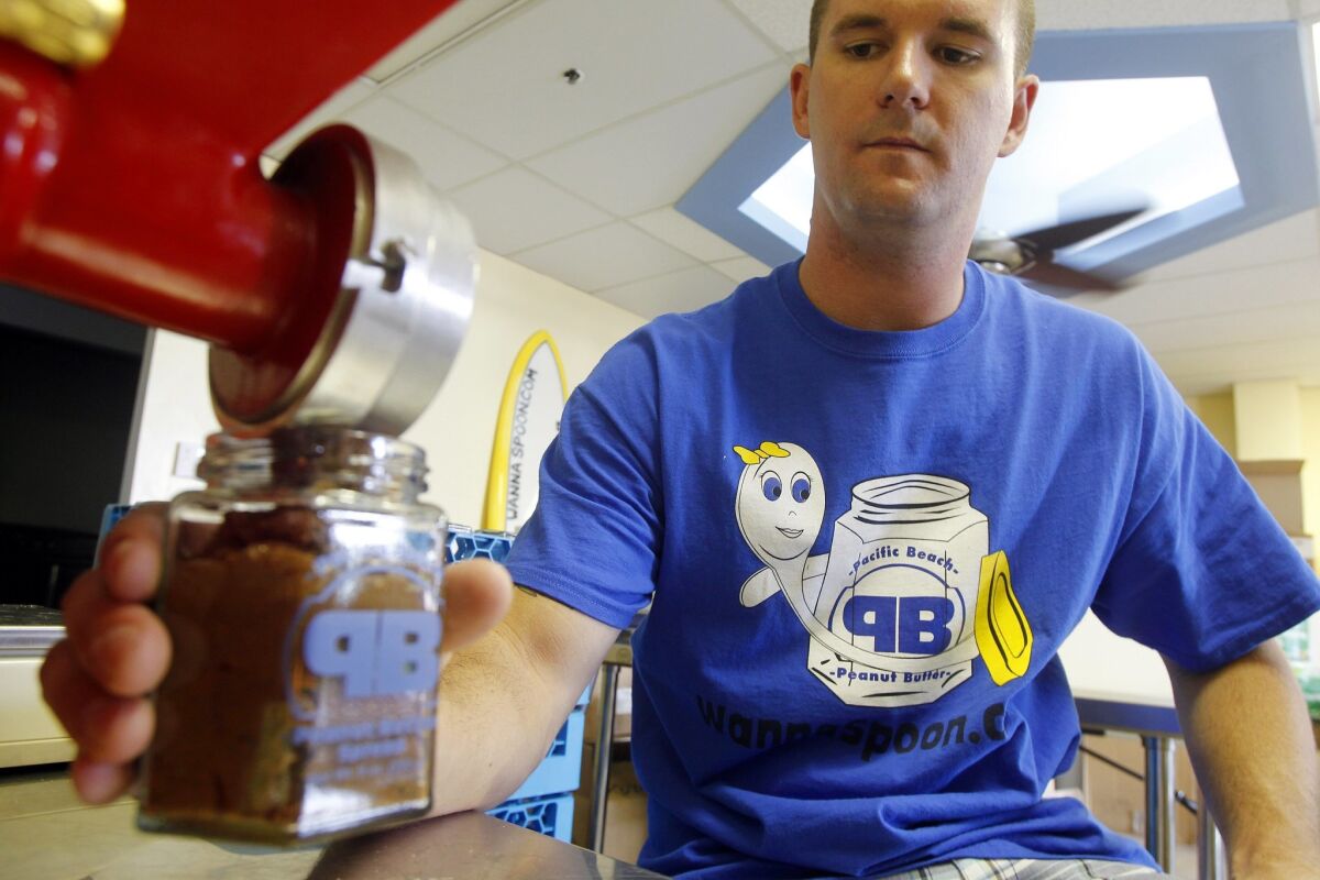 Matthew Mulvihill, owner of Pacific Beach Peanut Butter, makes a batch of peanut butter and M&Ms mix called "Child's Play" in San Diego, California. — Eduardo Contreras