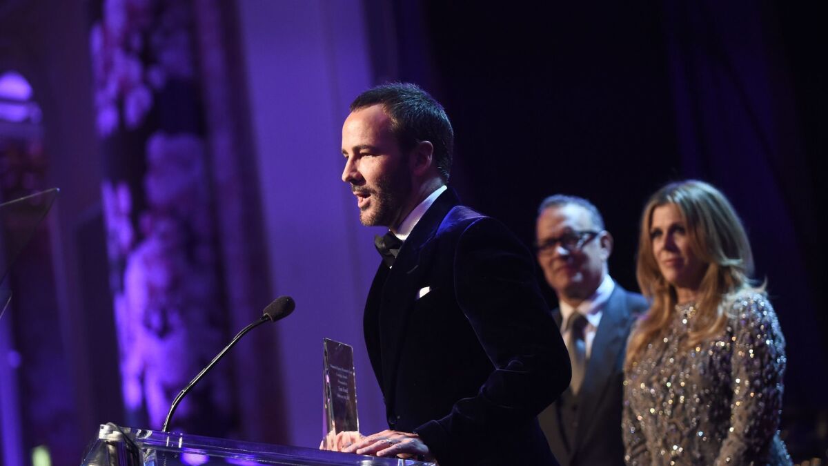 Tom Ford accepts the Courage Award from honorary co-chairs Rita Wilson and Tom Hanks during the Women's Cancer Research Foundation's An Unforgettable Evening on Feb. 16.