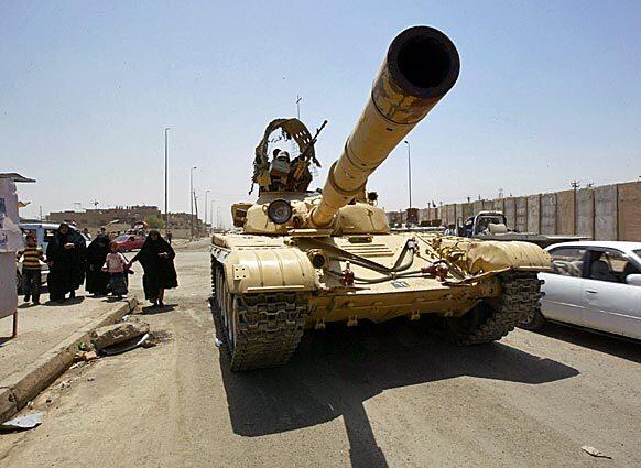 An Iraqi tank rolls into Sadr City in eastern Baghdad, after an agreement last week with anti-American cleric Muqtada Sadr's Mahdi Army to allow Iraqi troops into the district without resistance from the militia.