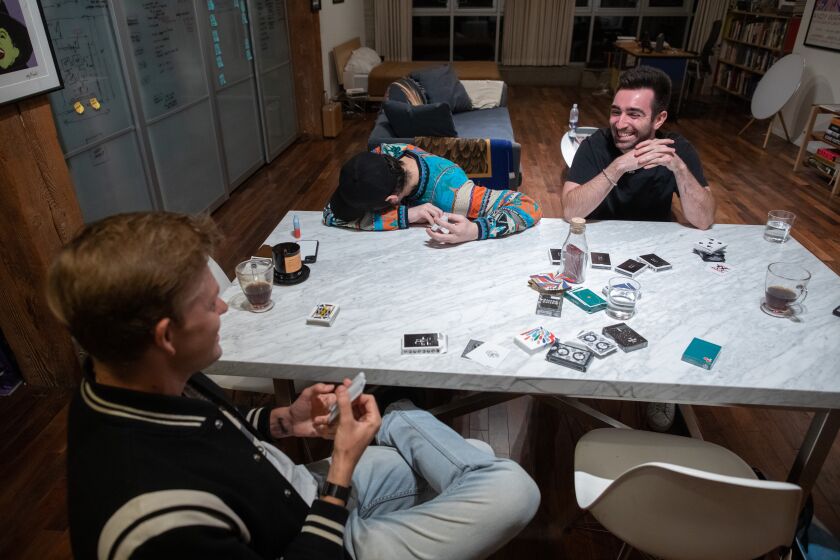 LOS ANGELES, CA - SEPTEMBER 23: Derek McKee, left, with fellow magicians Franco Pascali and Zach Davidson hone their sleight-of-hand skills during small gatherings called "magic jams." Photographed on Friday, Sept. 23, 2022 in Los Angeles, CA. (Myung J. Chun / Los Angeles Times)