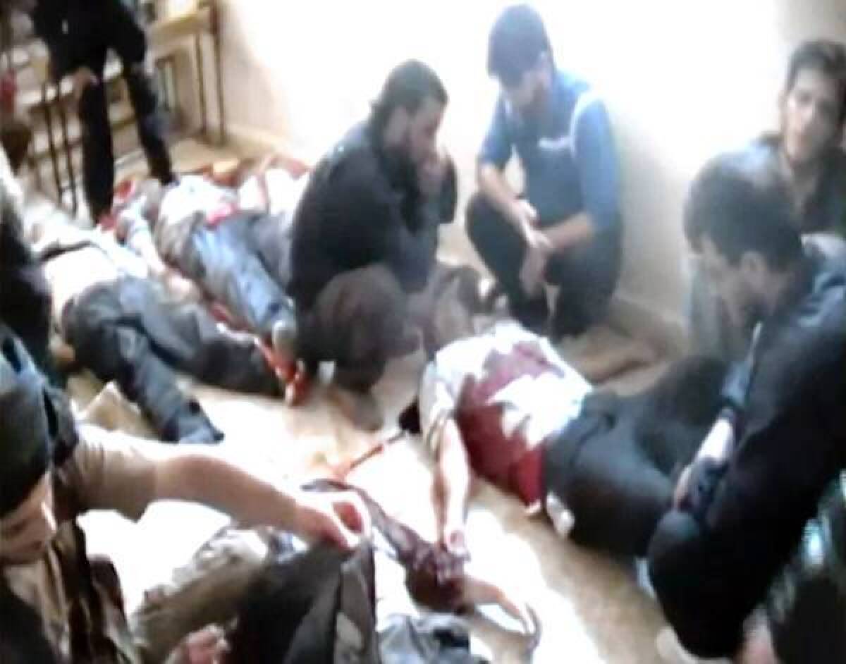 This image from an amateur video released by the Shaam News Network purportedly shows bodies of Syrian factory workers who were apparently killed execution-style near Qusair, in the central province of Homs.