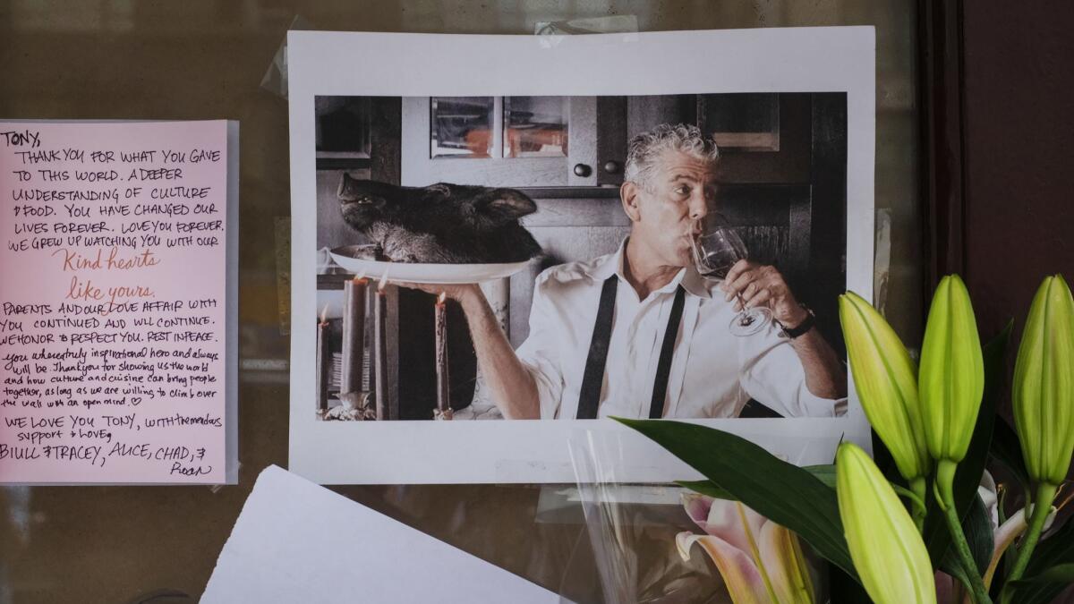 Notes, photographs and flowers are left in memory of Anthony Bourdain at the closed location of Brasserie Les Halles, where Bourdain used to work as the executive chef.