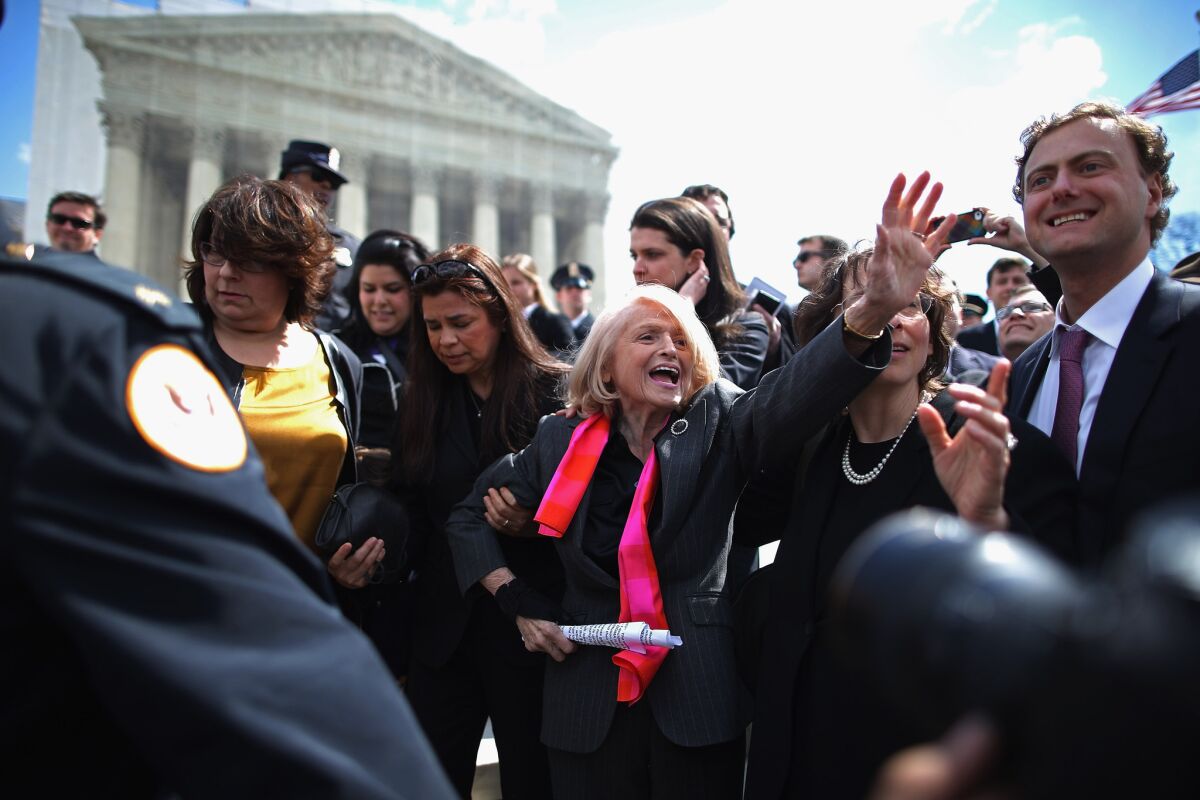 Edith Windsor, center, is mobbed by journalists and supporters as she leaves the Supreme Court in March 2013. She was the lead plaintiff in the case challenging the constitutionality of the Defense of Marriage Act.