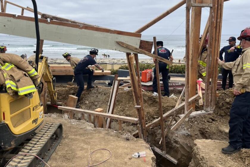 San Diego fire crews work to rescue man trapped in trench in La Jolla Shores