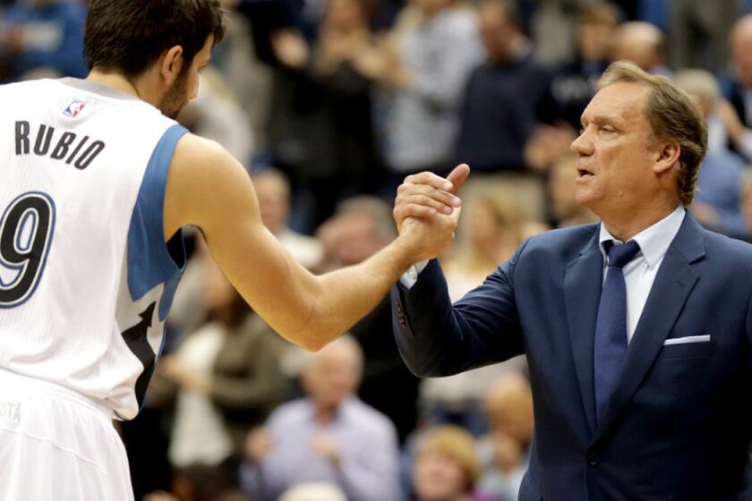 Timberwolves guard Ricky Rubio and Coach Flip Saunders celebrate after a 97-91 victory over the Pistons on Thursday.