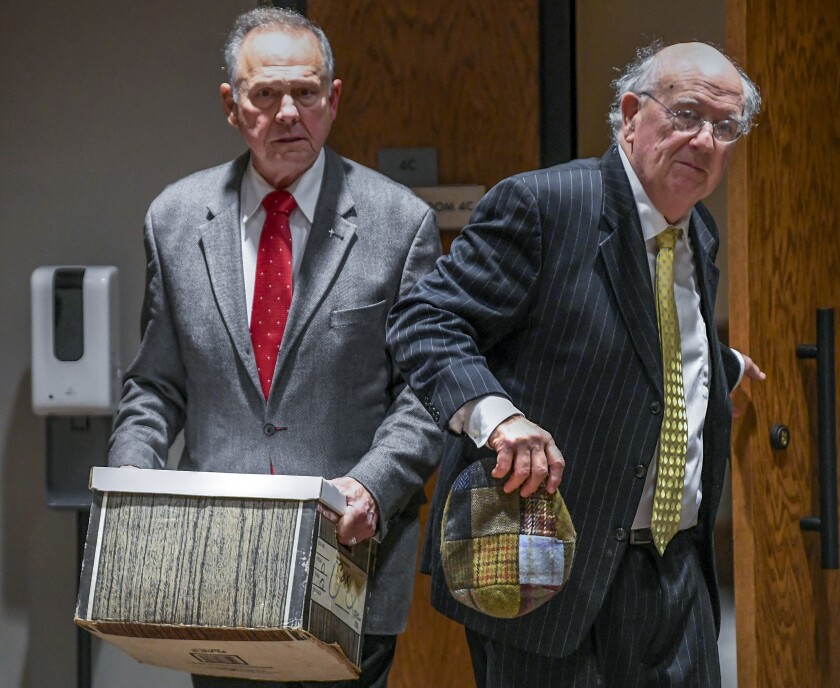 Former Alabama Chief Justice Roy Moore, left, and his attorney Julian McPhillips leave the courtroom in the Montgomery County Courthouse in Montgomery, Ala., on Monday, Jan. 24, 2022, following jury selection, as the trial with Leigh Corfman, who accused former Moore of sexual assault, and Moore's defamation lawsuits against each other begins. (Mickey Welsh/The Montgomery Advertiser via AP)