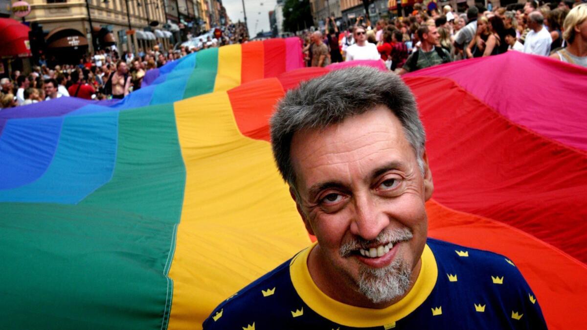 Gilbert Baker heads the 2003 Stockholm Pride Parade, helping to carry an 820-foot-long flag.