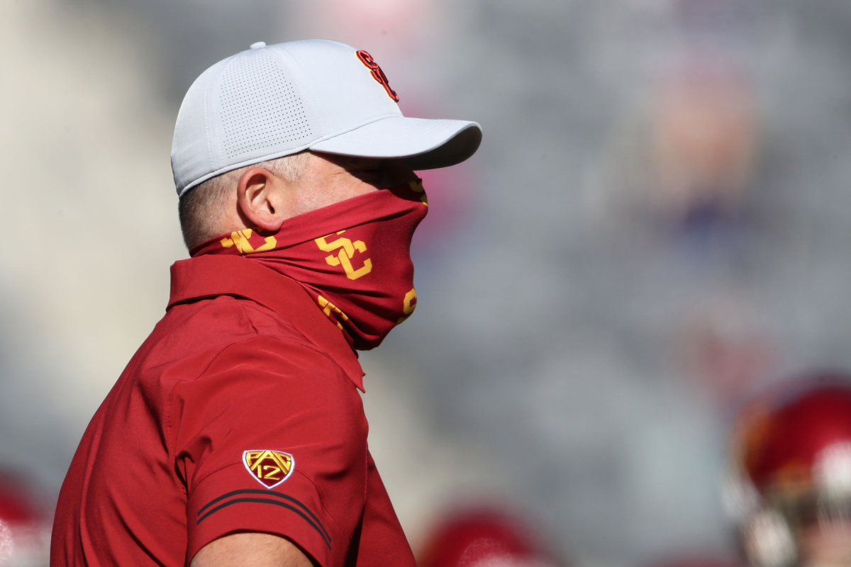 USC coach Clay Helton looks on during warmups before the Trojans faced Arizona on Nov. 14, 2020.