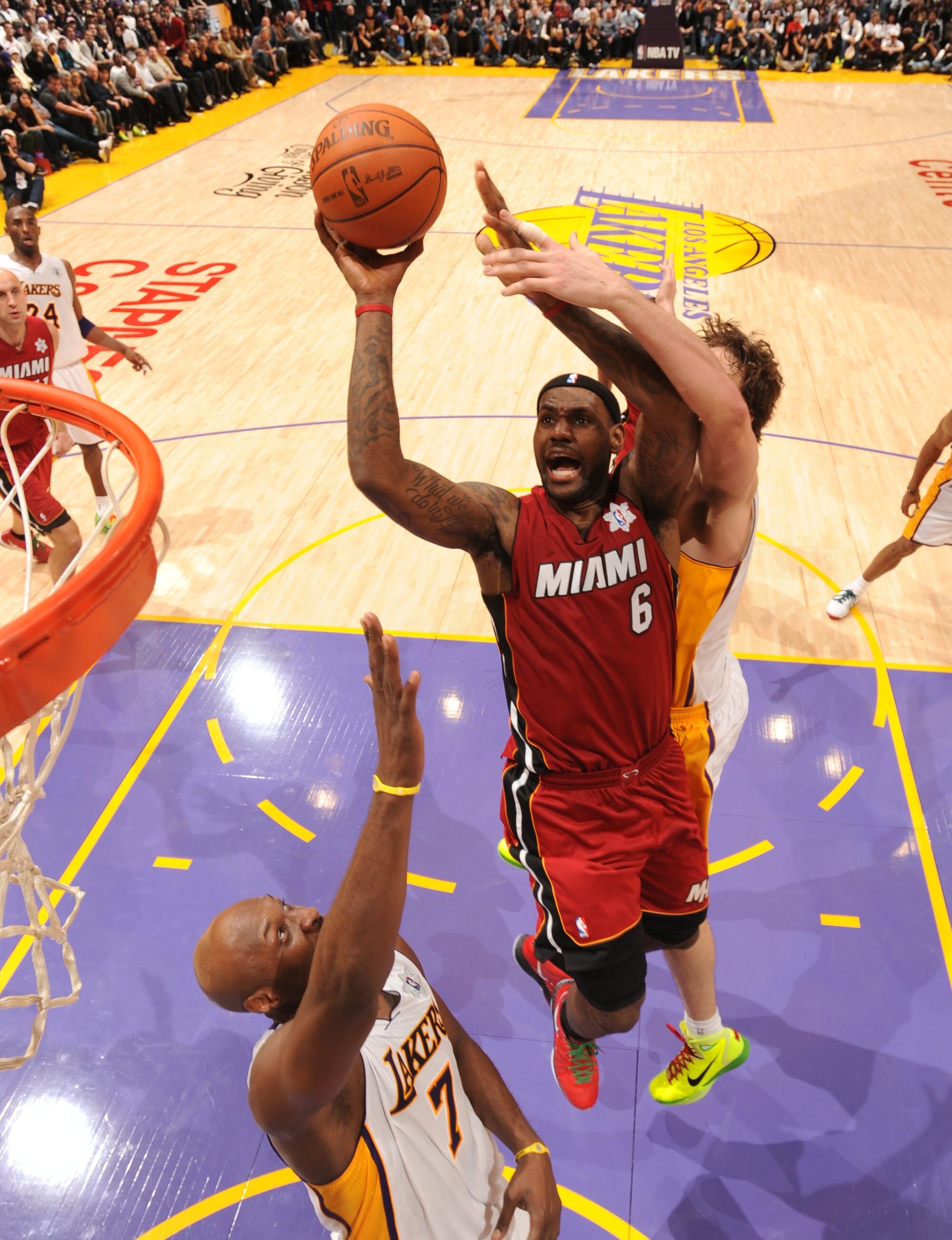 LeBron James rises for a shot in the lane while defended by Lakers forward Pau Gasol on Dec. 25, 2010, at Staples Center.